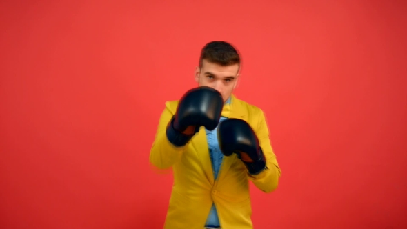 Guy In Yellow Jacket And Gloves Boxing