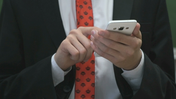 Businessman Writing The Text Using a Smartphone