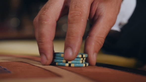 Man Checks Out His Card In Poker alt