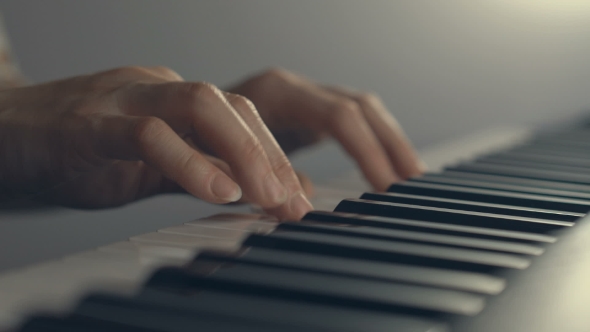 Woman's Hands On The Keyboard Of The Piano