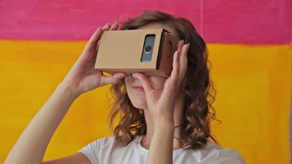 Young Curly Woman Using Virtual Reality Glasses