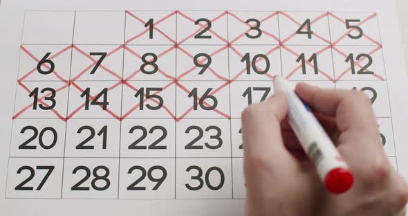 Man's Hand Write Down the 1617181920Th Day on the Paper Calendar alt