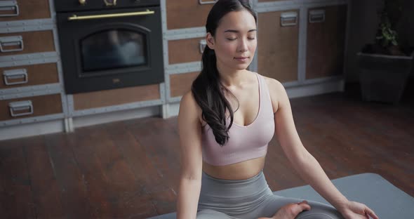 Healthy Asian Yoga Woman Sitting in Lotus Position and Smiling