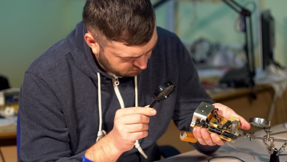 Engineer Looking at a Circuit Board.