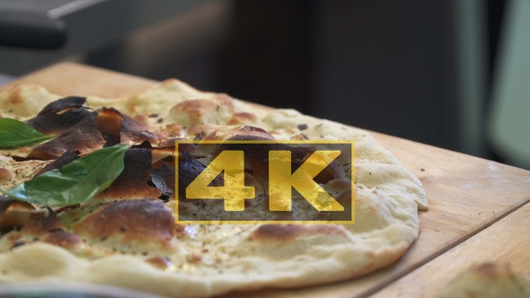 Trainee Chef Puts Basil Leaves On Focaccia