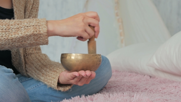 Young Woman In Cardigan Relaxing With Nepal Singing Bowl