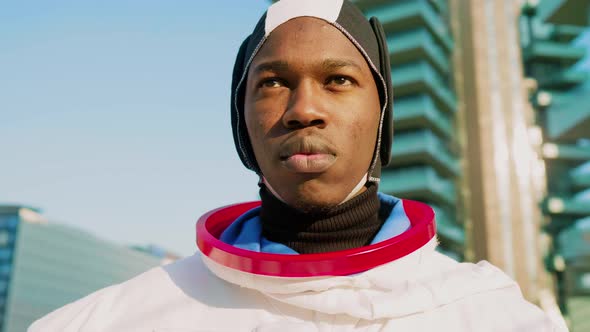 Astronaut with blank face expression looking at distance alt