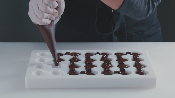 Of The Confectioner-cook Hands Squeezes Melted Chocolate