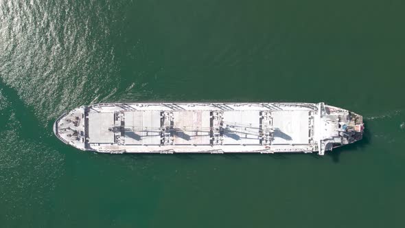 Aerial top down view of rdry cargo ship floats. Ship logistic and transportation business industry. alt