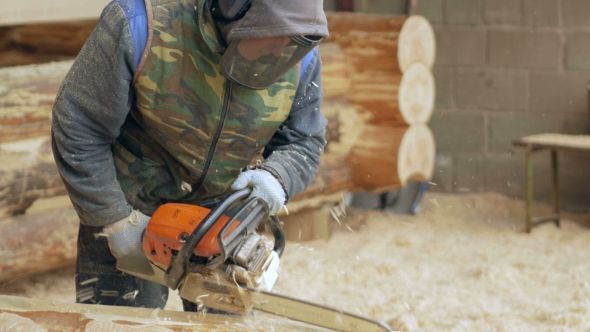 Man Makes Curly Cutting Wood Chainsaw. The Log Will Be Part Of The Future Of The Wooden House