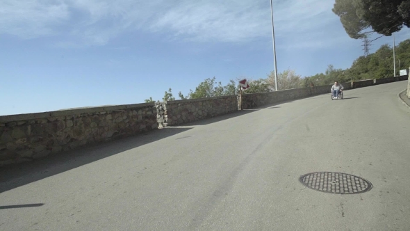 Man In Wheelchair Down The Road