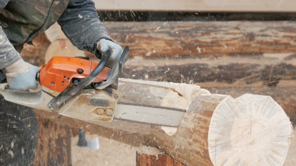 Construction Worker Cuts Wood Chainsaw For Future Home
