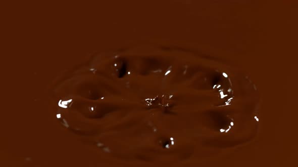 Super Slow Motion Detail Shot of Chocolate Liquid Drop at 1000 Fps alt