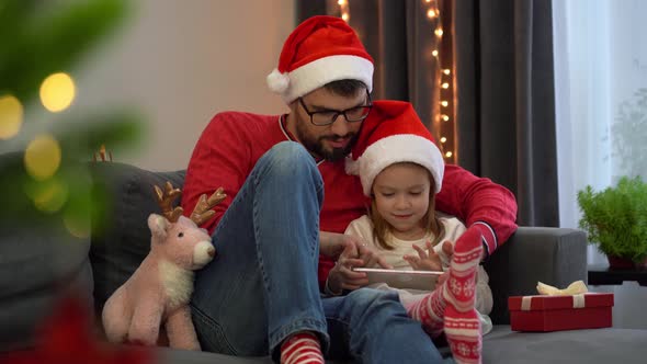 Father and Girl Buy Gifts in Online Store By Tablet