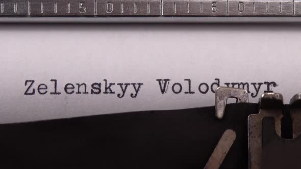 Typing name of the President of Ukraine "Zelenskyy Volodymyr" on retro typewriter. alt