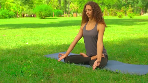 Young Caucasian Girl Trains Yoga Outdoor alt