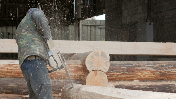 Man Cuts Wood Chainsaw For Future Home