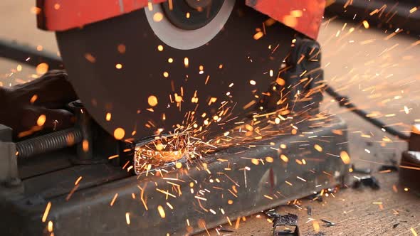 Worker cutting metal and spark with cutting machine