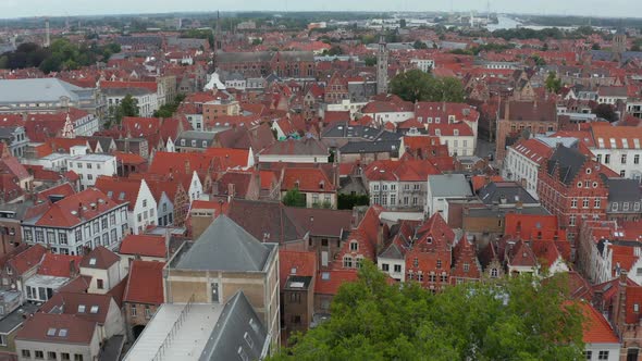 Cityscape Over Bruges, Belgium with Red Rooftops with Churches From Aerial Perspective alt