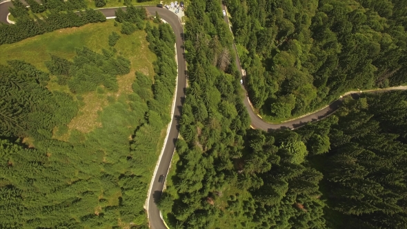 Cars Driving On The Forested Road In Mountains