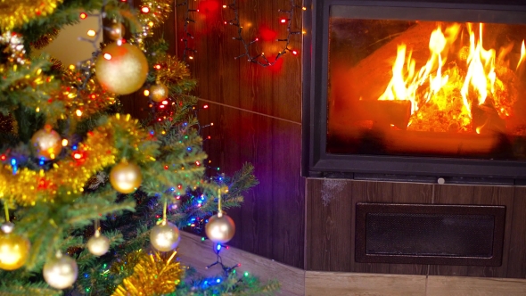 Roasted Chicken On Christmas Table In Front Of Fireplace And Tree With Lights