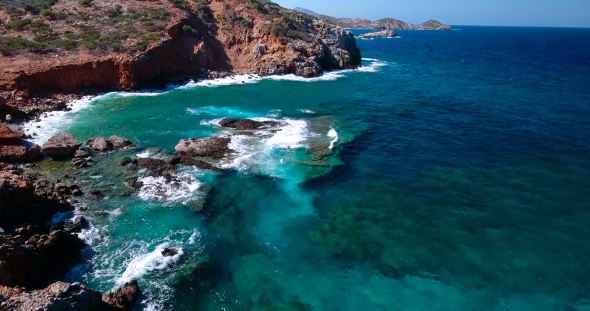 Blue Sea, Waves Breaking In Cliffs At Shore