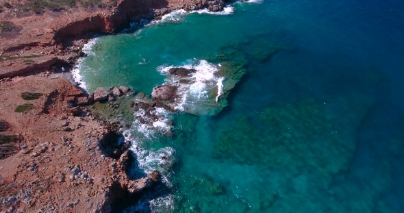 Blue Sea, Waves Breaking In Cliffs At Shore