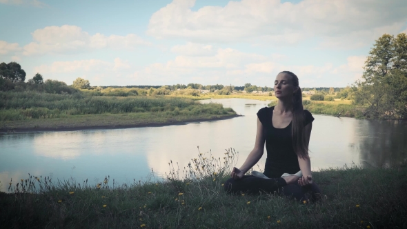 Girl In Good Physical Shape, On a Background Of Nature, The River And Clouds