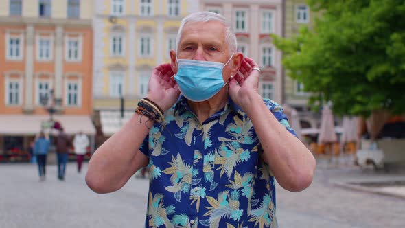 Coronavirus Pandemic Portrait of Senior Stylish Tourist Man Grandfather Wearing Protective Mask alt