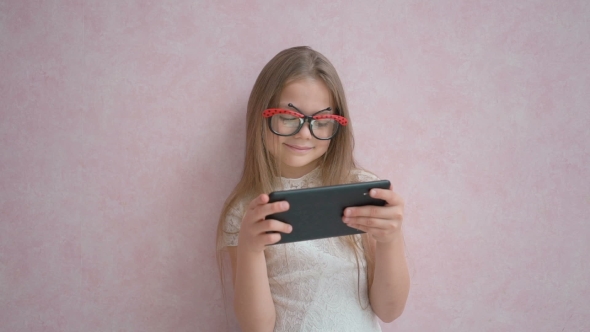 Cute Child Holding The Tablet Computer
