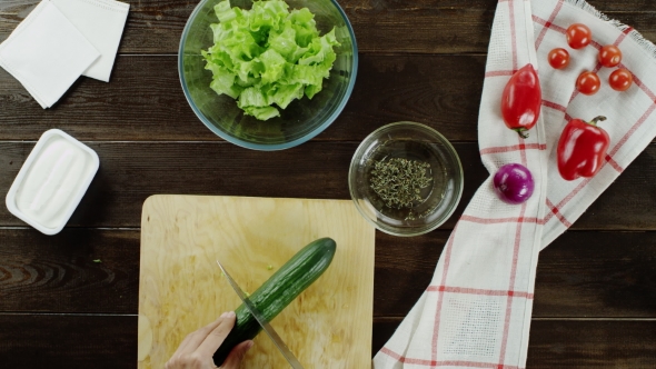 Cooking Salad On a Wooden Table
