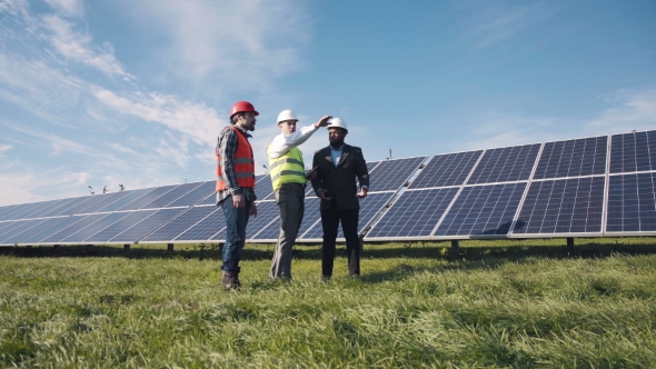 Three Engineers And Solar Panels. alt