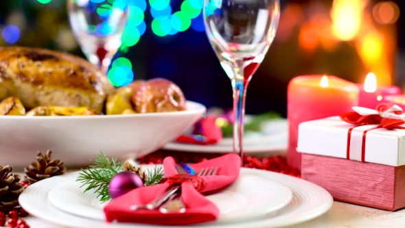 Roasted Chicken On Christmas Table In Front Of Fireplace And Tree With Lights