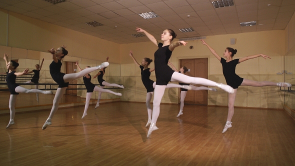 Group Of Ballet Dancers Jumping In The Air alt