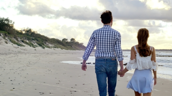 Walking Couple On The Beach