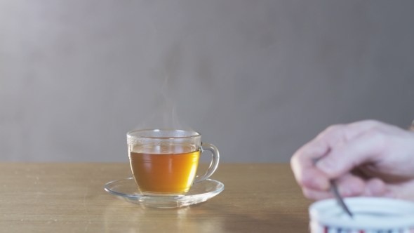 Man Putting Sugar Into a Cup alt