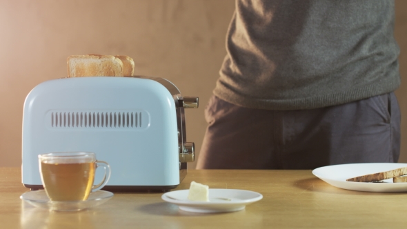Man Butters a Loaf Of Bread alt