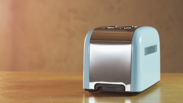 Two Loaves Of Bread Jumping Out Of An Electric Toaster alt