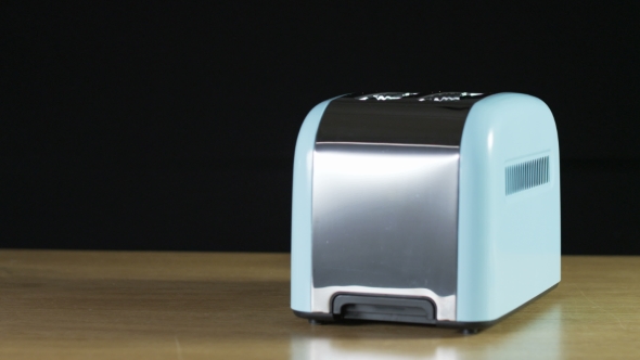 Two Loaves Of Bread Jumping Out Of An Electric Toaster