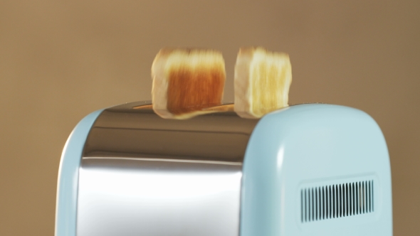 Two Loaves Of Bread Jumping Out Of An Electric Toaster alt