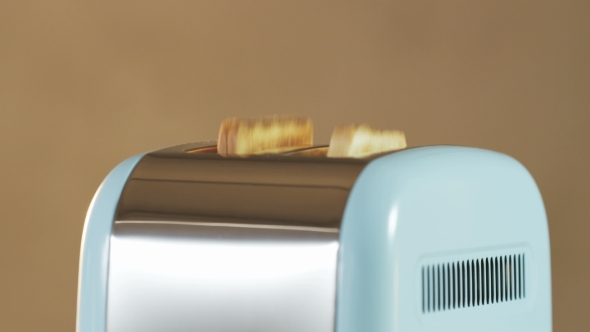 Two Loaves Of Bread Jumping Out Of An Electric Toaster alt