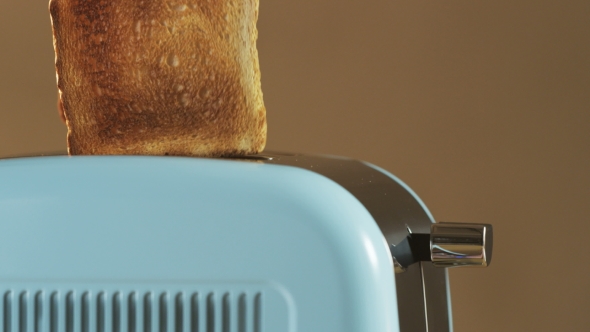 Two Loaves Of Bread Jumping Out Of An Electric Toaster alt
