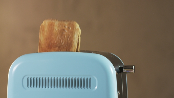 Two Loaves Of Bread Jumping Out Of An Electric Toaster alt