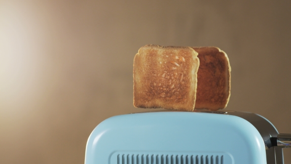 Two Loaves Of Bread Jumping Out Of An Electric Toaster alt