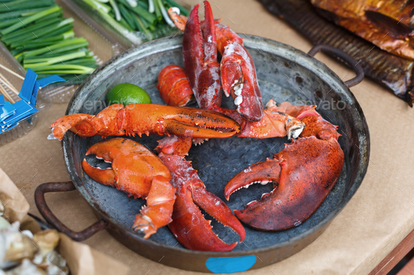 Plenty of seafood, roasted lobster claws on grill pan
