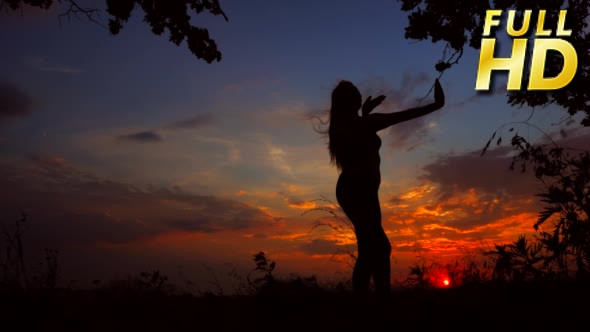 Silhouette Against Red Orange Sunset of One Young