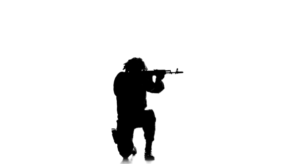 Soldier Stands On One Knee And Aiming a Gun. Silhouette alt