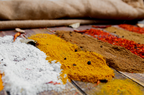 Colourful spices on the table. Various Spices in on wooden background. Spices background.