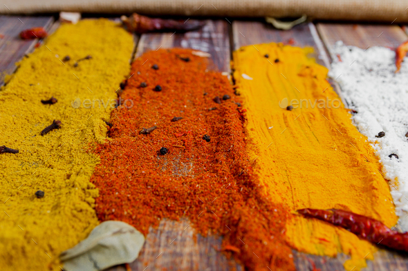 Colourful spices on the table. Various Spices in on wooden background. Spices background