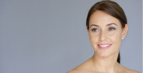 Smiling Young Woman In Brown Hair With Copy Space alt